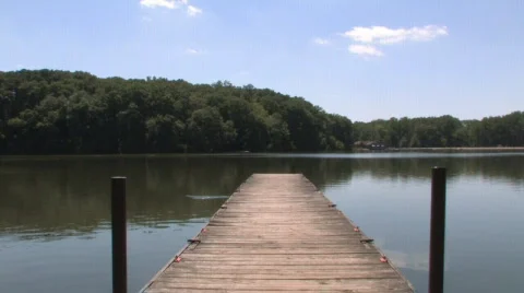A Fish Jumps by a Small Pier Stock Footage 493954