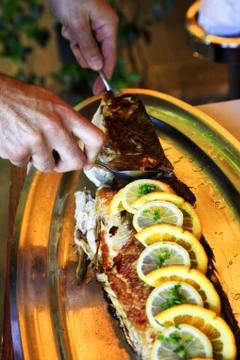 Fish with a lemon at restaurant Stock Photos