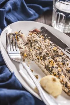 Fish mackerel baked with herbs, mashed potatoes, pesto sauce served on a wh.. Stock Photos