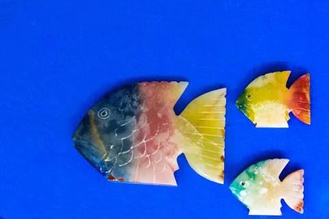 Fish made of stone on a colored background 写真素材