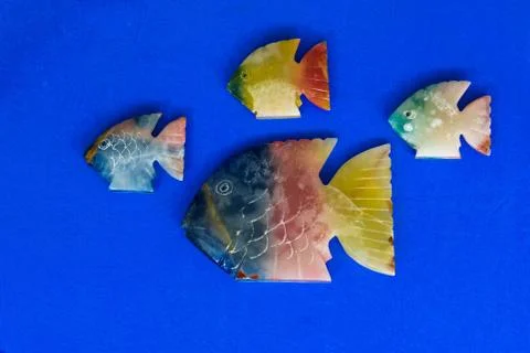 Fish made of stone on a colored background 스톡 사진