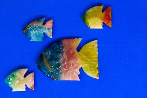 Fish made of stone on a colored background 스톡 사진