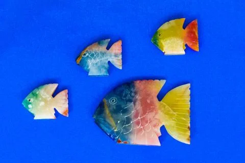 Fish made of stone on a colored background Stock Photos