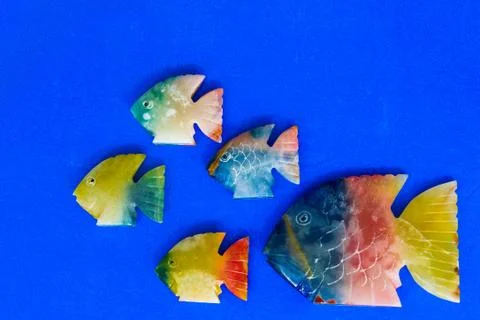 Fish made of stone on a colored background 写真素材