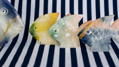 Fish made of stone on a colored background Foto stock