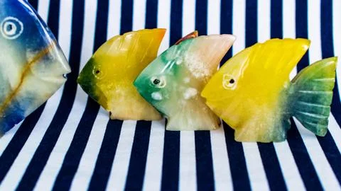 Fish made of stone on a colored background Stock Photos