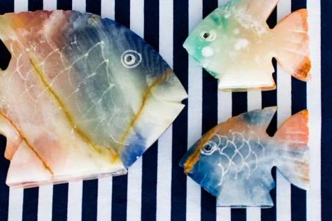 Fish made of stone on a colored background Foto stock