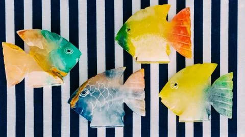 Fish made of stone on a colored background Stock Photos
