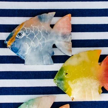 Fish made of stone on a colored background Foto stock