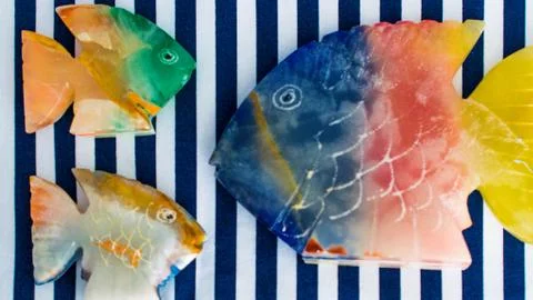 Fish made of stone on a colored background Stock Photos