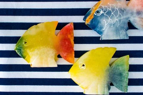 Fish made of stone on a colored background 스톡 사진