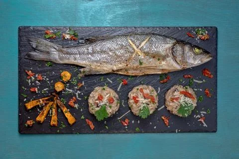 Fish with mushroom rizotto black Stock Photos