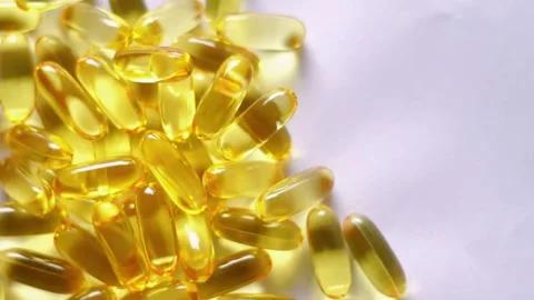 Fish oil capsules, cod liver capsules, omega 3 capsules video footage. 4k Stock Footage 295924252
