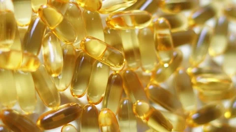 Fish oil capsules, cod liver oil capsules, omega 3 capsules rotation background Stock Footage 296037288