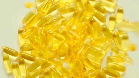 Fish oil on a light background.Falling fish oil capsules.omega fatty acids. Stock Footage 158540616
