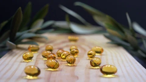 Fish oil, omega-3 liquid gel yellow capsules vitamin supplement pills. Stock Footage