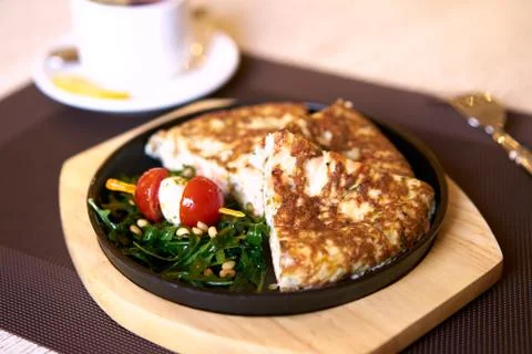 Fish omelet with arugula Stock Photos