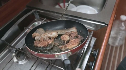 Fish on the pan at the boat kitchen Stock Footage 74109250