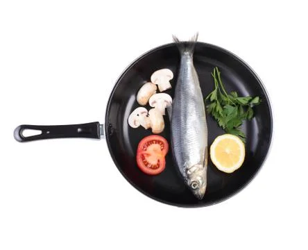 Fish in pan with vegetables Stock Photos