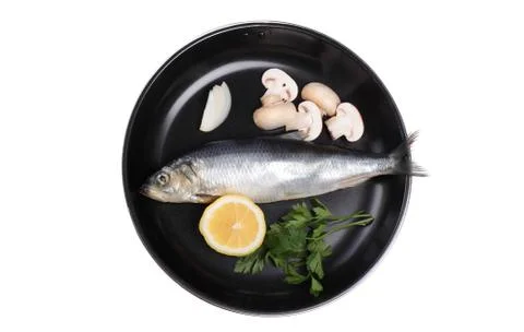 Fish in pan with vegetables Stock Photos