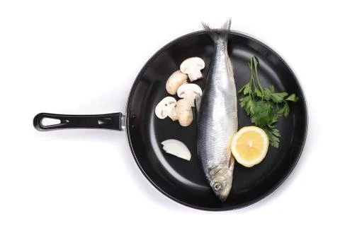 Fish in pan with vegetables Stock Photos