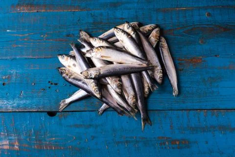 Fish pattern. Herring fish on an old blue wooden background. Stock Photos