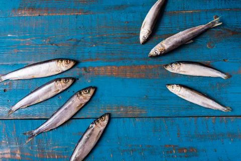 Fish pattern. Herring fish on an old blue wooden background. Stock Photos