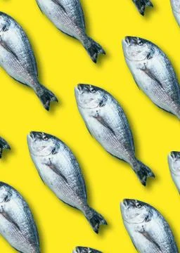 Fish pattern on yellow background. Top view. Creative design for packaging. Food Foto stock