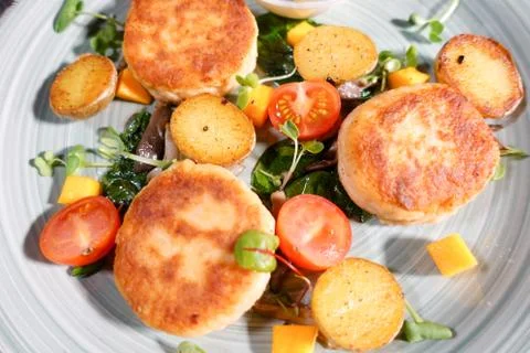 Fish patties with a side dish Stock Photos