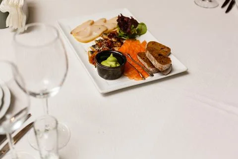 Fish platter in restaurant. Slices of salmon fish, smoked eel, white escolar Stock Photos
