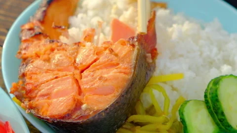 Fish with rice and vegetables close-up, Asian lunch using bamboo sticks Stock Footage 170426587