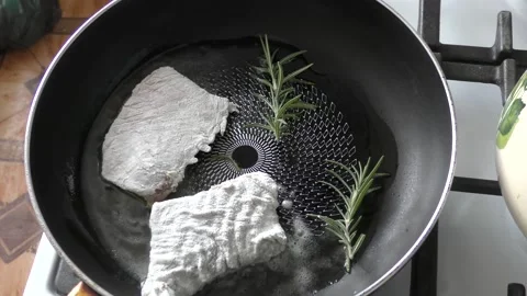 Fish with rosemary is fried in a pan Stock Footage 167753684