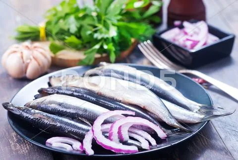 Fish with salt and spice on the plate Stock Photos
