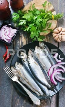 Fish with salt and spice on the plate Stock Photos