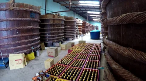 Fish sauce factory camera tilts up showing filled bottles and production tubs 4k Stock Footage 55861183