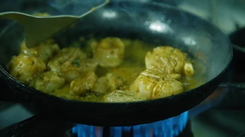 Fish scallops being fried on hob with frying pan cooking Stock Footage 130977492
