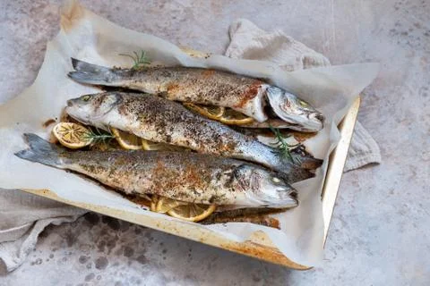 Fish seabass roasted with lemon Stock Photos