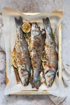 Fish seabass roasted with lemon Stock Photos