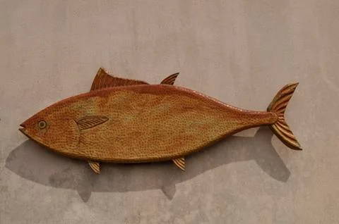 Fish shape of clay on the wall with text space for your logo Stock Photos