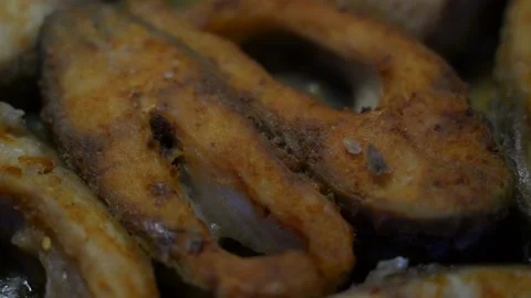 Fish slices with appetizing crispy crust fry in pan macro Video stock 237713398