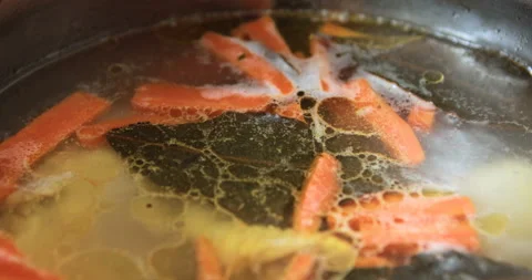 Fish soup is boiling in a pot on the kitchen Stock Footage 108385777