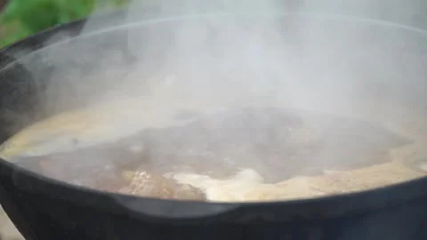 Fish soup is cooked on a fire Stock Footage 140381990