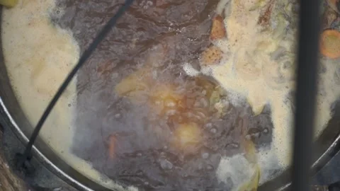 Fish soup is cooked on a fire Stock Footage 140382035