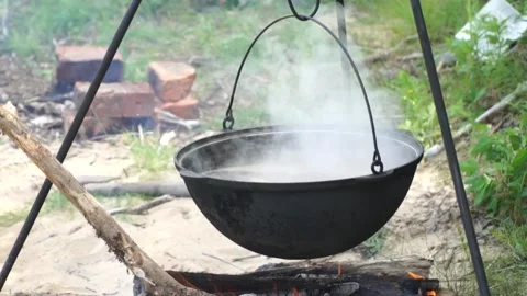 Fish soup is cooked on a fire Stock Footage 140382051