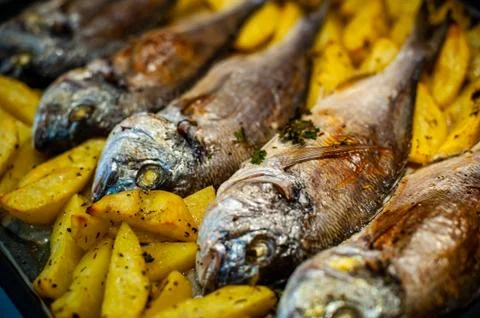 Fish Sparus aurata for baking with potatoes and greens Stock Photos