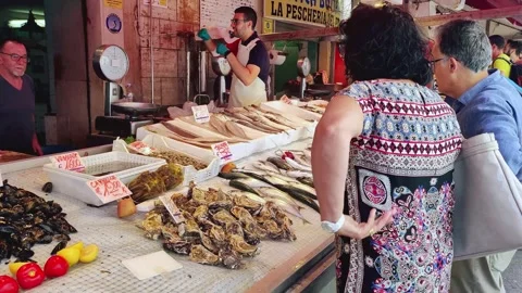A fish stall in a crowded open-air food market with fresh seafood Stock Footage 249007399