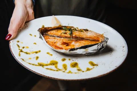 Fish steak on a plate Stock Photos