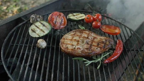 Fish steak with a slice of tomato, zucchini, cherry tomato, garlic clove, chilli Stock Footage 93346680