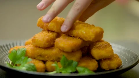 Fish sticks. Children take cooked fish sticks with their hands, close-up Stock Footage 220367353