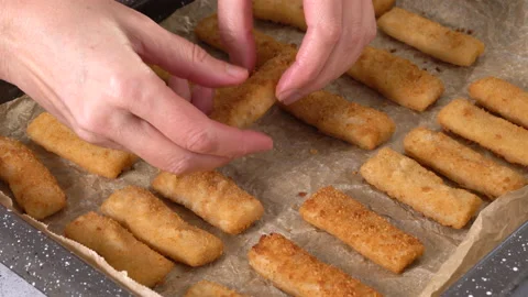 Fish sticks made from wild-caught Alaskan Pollock close-up on a baking pan Vidéo 223379425